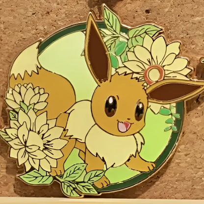 A cheerful tan eevee enamel pin with brown ears and white fur surrounded by cream flowers for gengar anime elf fans