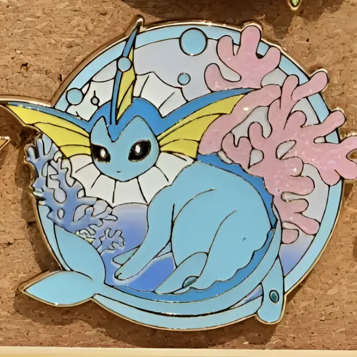 Gengar anime elf enamel pin featuring a light blue and yellow eevee with a fish tail surrounded by coral design