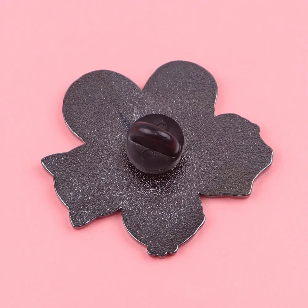 Black enamel pin shaped like a five-petaled flower with matte enamel finish and dark plastic clasp for kawaii elf anime enamel design