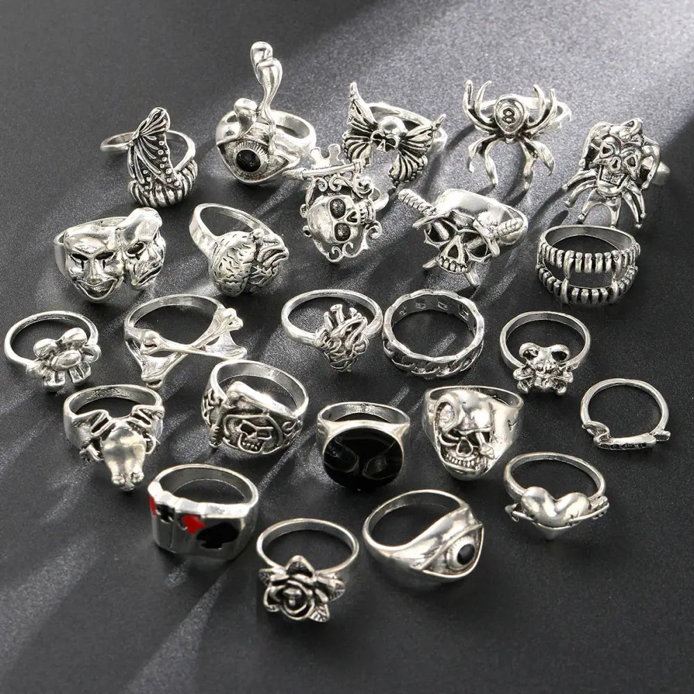 Gothic skeleton ring set with 24 silver-toned skull and spider rings featuring intricate punk jewelry designs