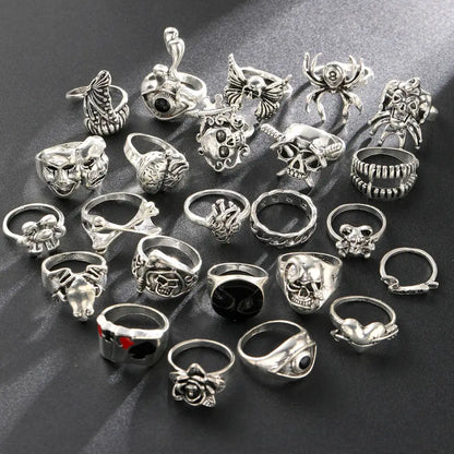Gothic skeleton ring set with 24 silver-toned skull and spider rings featuring intricate punk jewelry designs