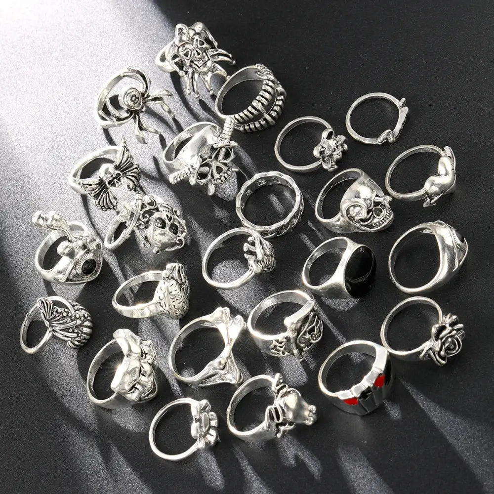 Silver-toned gothic skeleton ring set with intricate skull and spider designs in a 24pcs punk jewelry collection