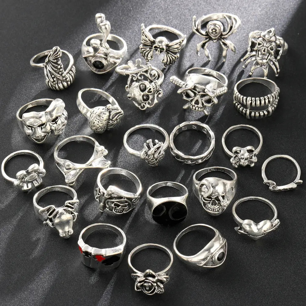 Silver-toned gothic skeleton ring set 24pcs featuring intricate skulls spiders roses and hearts designs for punk style
