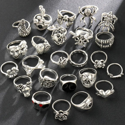 Silver-toned gothic skeleton ring set 24pcs featuring intricate skulls spiders roses and hearts designs for punk style