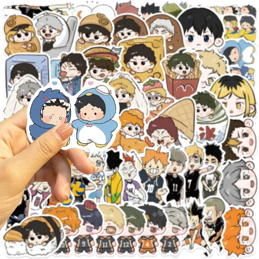 A hand holds a blue penguin-themed sticker from the Haikyuu graffiti sticker set featuring anime characters