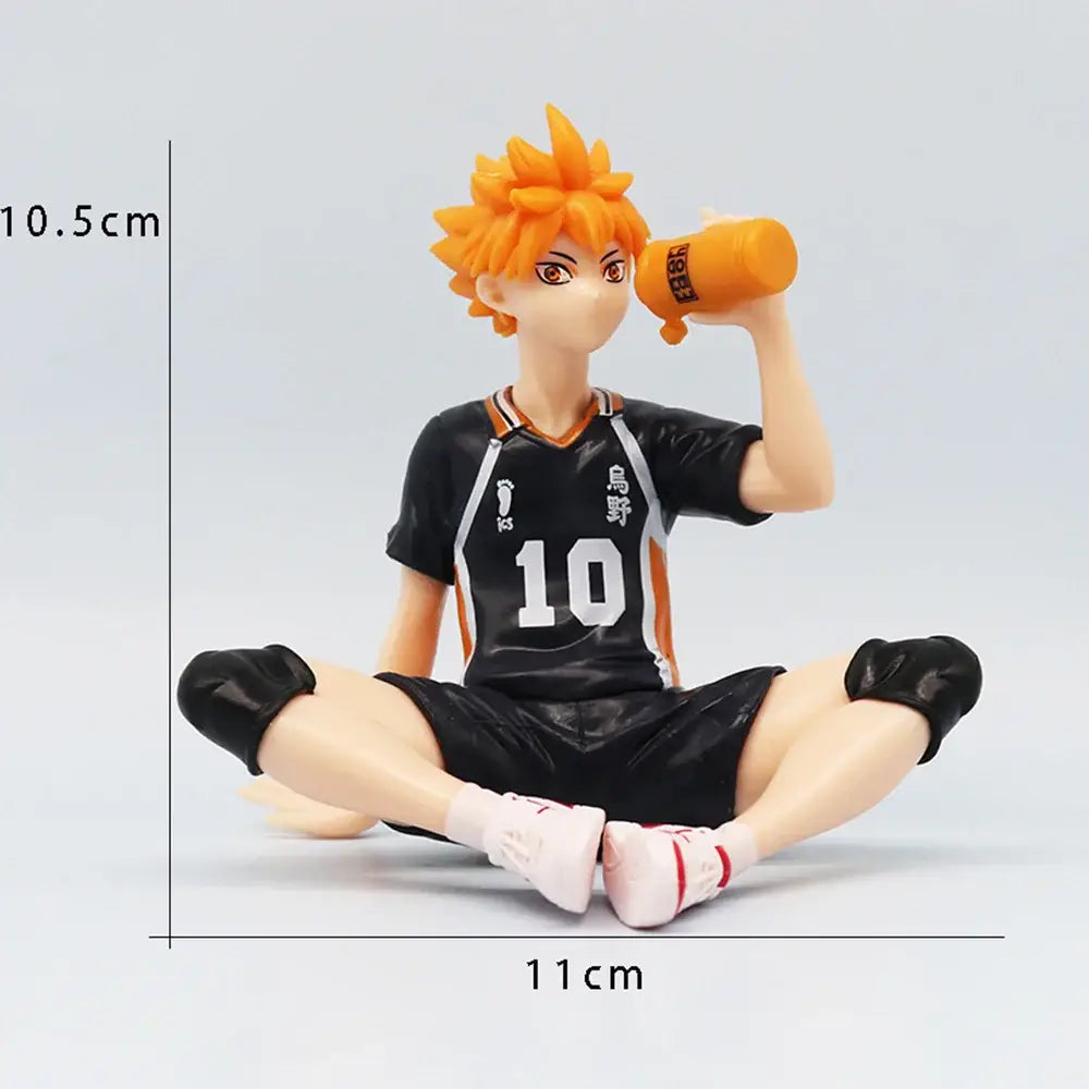Haikyuu shoyo hinata noodle stopper pvc figure of orange-haired player in black and orange jersey holding water bottle sitting cross-legged