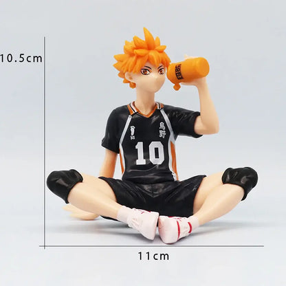 Haikyuu shoyo hinata noodle stopper pvc figure of orange-haired player in black and orange jersey holding water bottle sitting cross-legged