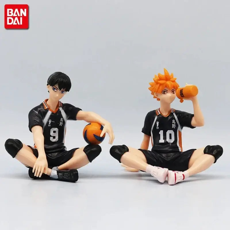 Two black and orange pvc volleyball figures from haikyuu shoyo hinata noodle stopper set with jersey numbers 9 and 10