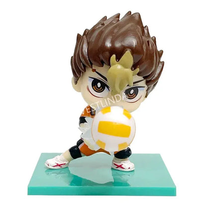 Chibi-style haikyuu shoyo hinata pvc statue with spiky brown hair and yellow streaks holding a white and yellow volleyball