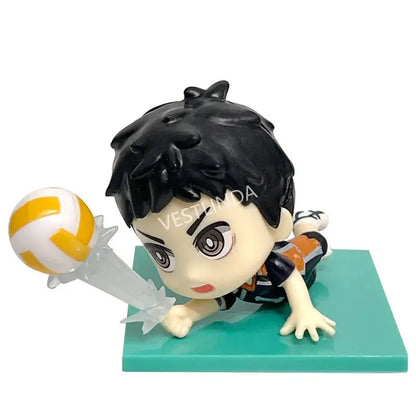 Chibi-style haikyuu shoyo hinata pvc statue with black spiky hair holding yellow and white volleyball on teal base