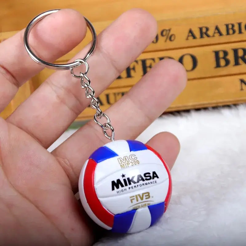 Haikyuu volleyball pvc keychain featuring a miniature mikasa volleyball with red white and blue panels and gold lettering