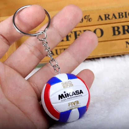 Haikyuu volleyball pvc keychain featuring a miniature mikasa volleyball with red white and blue panels and gold lettering