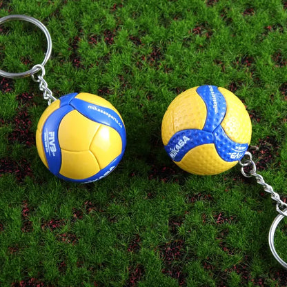 Yellow and blue mikasa volleyball pvc keychains with textured surfaces and metallic chains for haikyuu sports fans