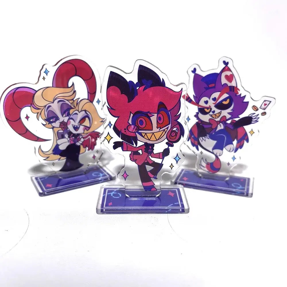 Three colorful transparent acrylic character stands with glittery pink purple and red designs hazbin hotel alastor figure