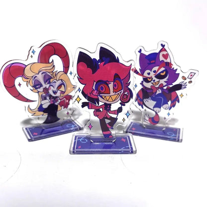 Three colorful transparent acrylic character stands with glittery pink purple and red designs hazbin hotel alastor figure