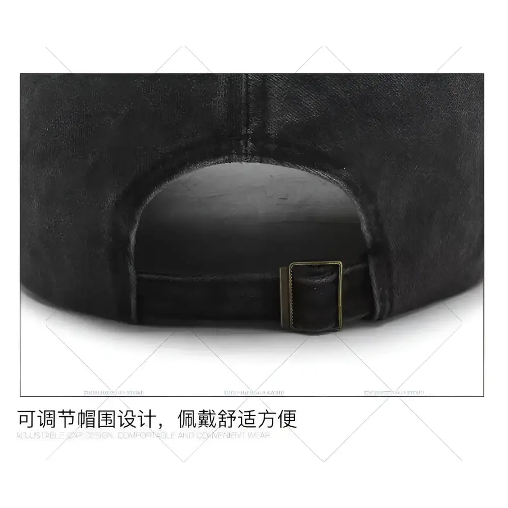 Black denim dad hat with kitty distressed embroidery and brass-colored adjustable strap buckle on the back side