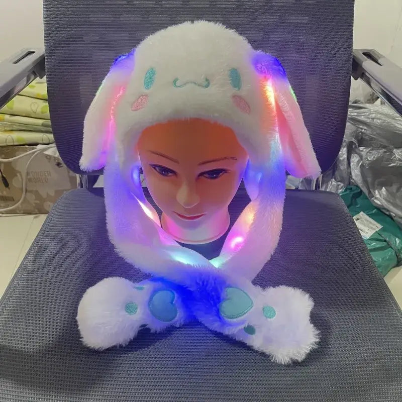 Hello kitty plush winter hat in white plush with light-up moving ears and paw-shaped scarf for cold weather use