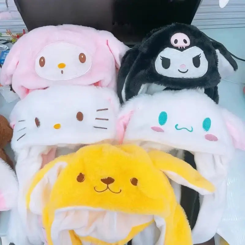 A collection of kitty plush winter hats in pink black white and yellow with soft fur light-up moving ears and embroidered faces