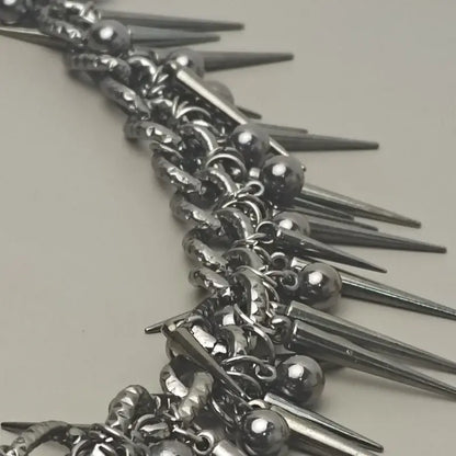 Silver spiked choker necklace with metallic balls and chain links paired with black gun metal biker pants chain