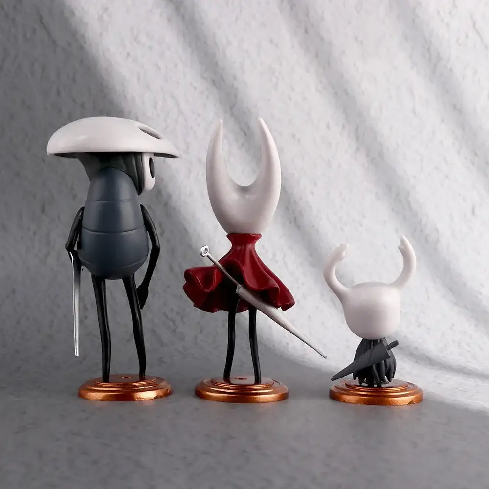 Hollow knight pvc figure set featuring three black and white anime figures with one red cape sword holder for figure collection