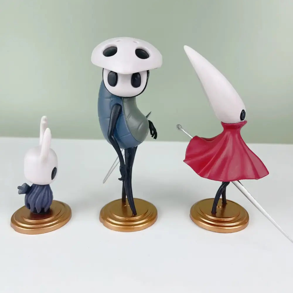 White and blue hollow knight anime figure with black eyes standing on a gold base pvc statue for figure collection
