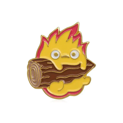 Yellow and pink flame-shaped calcifer enamel pin featuring a cartoon character behind a brown log from moving castle