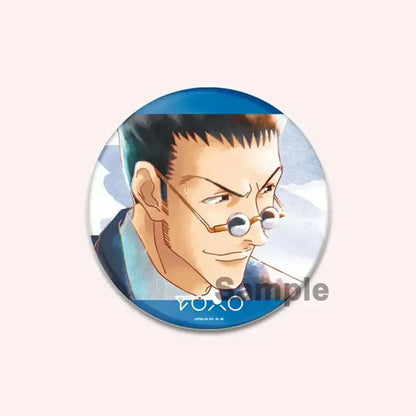 Circular hunter x hunter character pin featuring an anime character with dark hair and round silver glasses on blue shirt