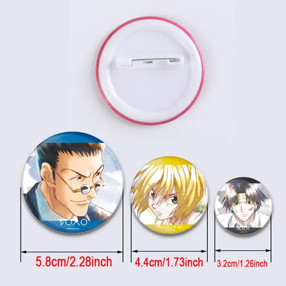 Three circular hunter x hunter character pins with pink yellow and silver metallic frames handmade badge