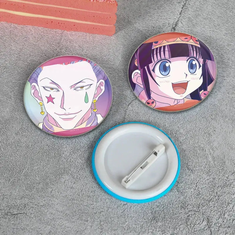 Two handmade hunter x hunter character pins featuring a purple-haired male and smiling dark-haired female anime badges