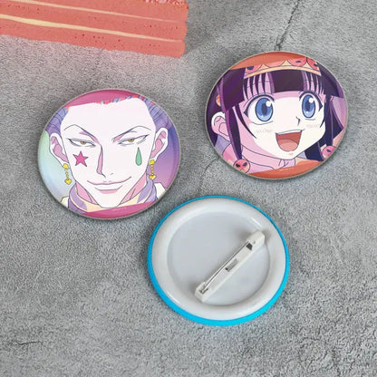 Two handmade hunter x hunter character pins featuring a purple-haired male and smiling dark-haired female anime badges