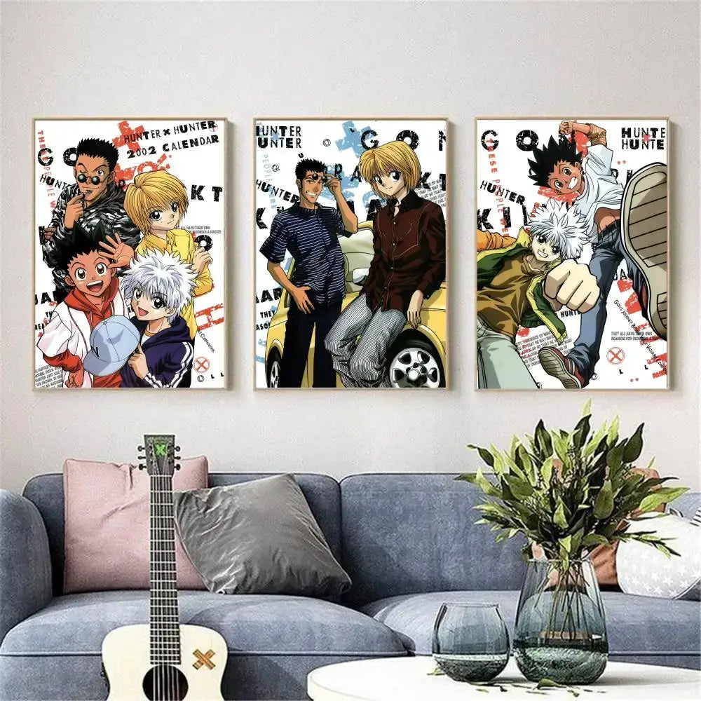 Three framed hunter x hunter hisoka wall posters with colorful character art mounted above a gray sofa