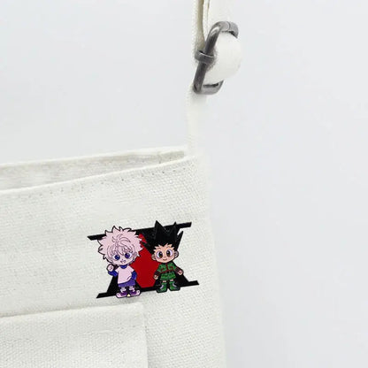 Hunter x hunter enamel pin featuring pink-haired and black-haired cartoon characters in a red stylized h cartoon badge