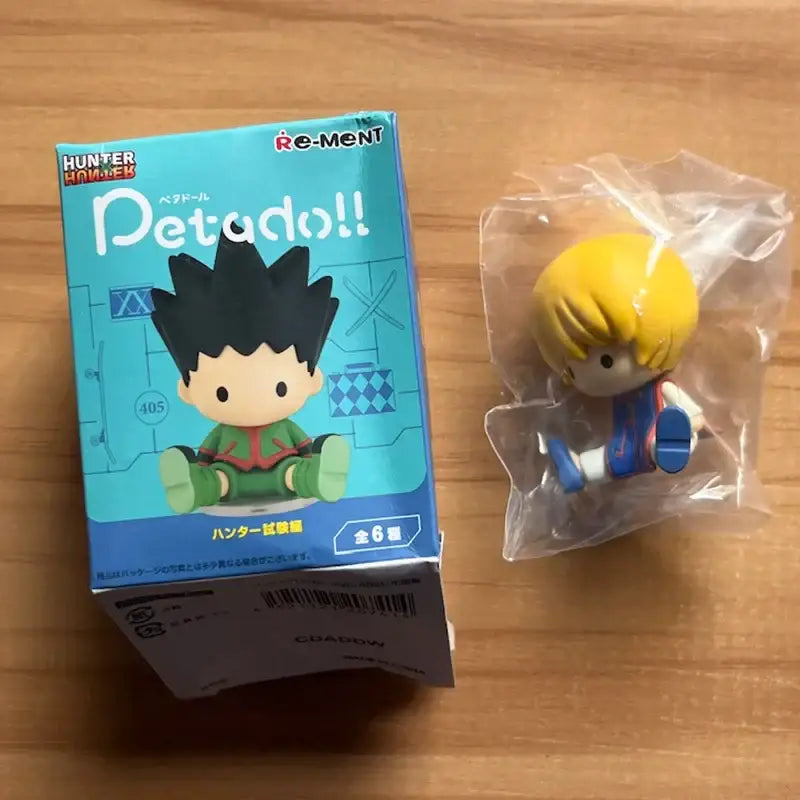Yellow-haired hunter x hunter killua zoldyck blind box chibi anime figure in blue white outfit with green shoes packaged in plastic