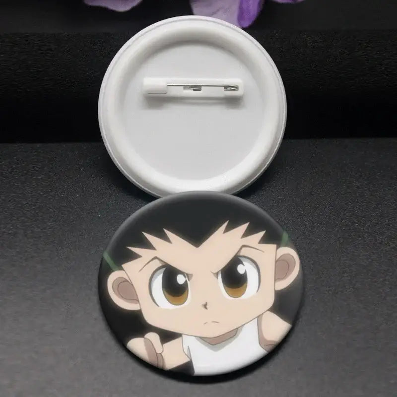 Black circular hunter x hunter kurapika brooch pin featuring a cartoon character with spiky hair and wide eyes