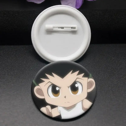 Black circular hunter x hunter kurapika brooch pin featuring a cartoon character with spiky hair and wide eyes