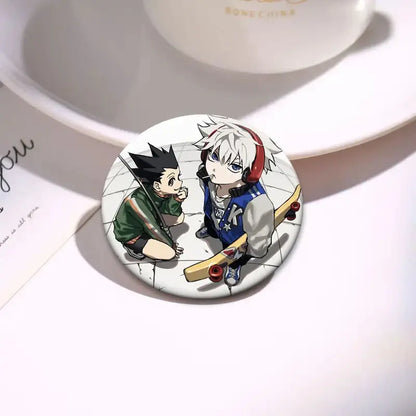 Circular hunter x hunter kurapika brooch pin featuring anime characters with black spiky hair and white hair on tiled floor
