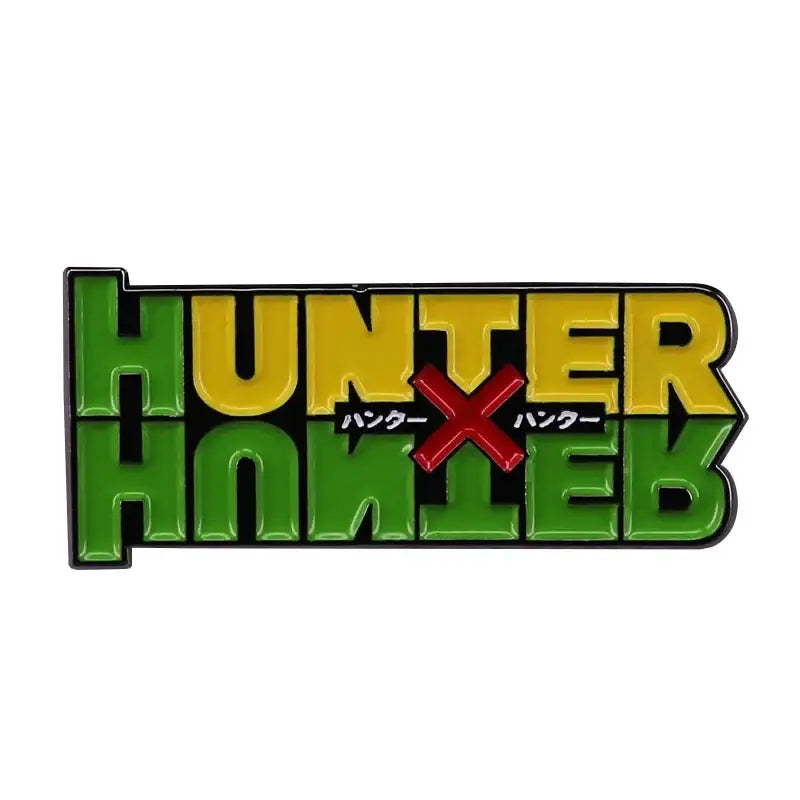 Green and yellow enamel hunter x hunter logo brooch with red x and japanese text fantasy adventure badge