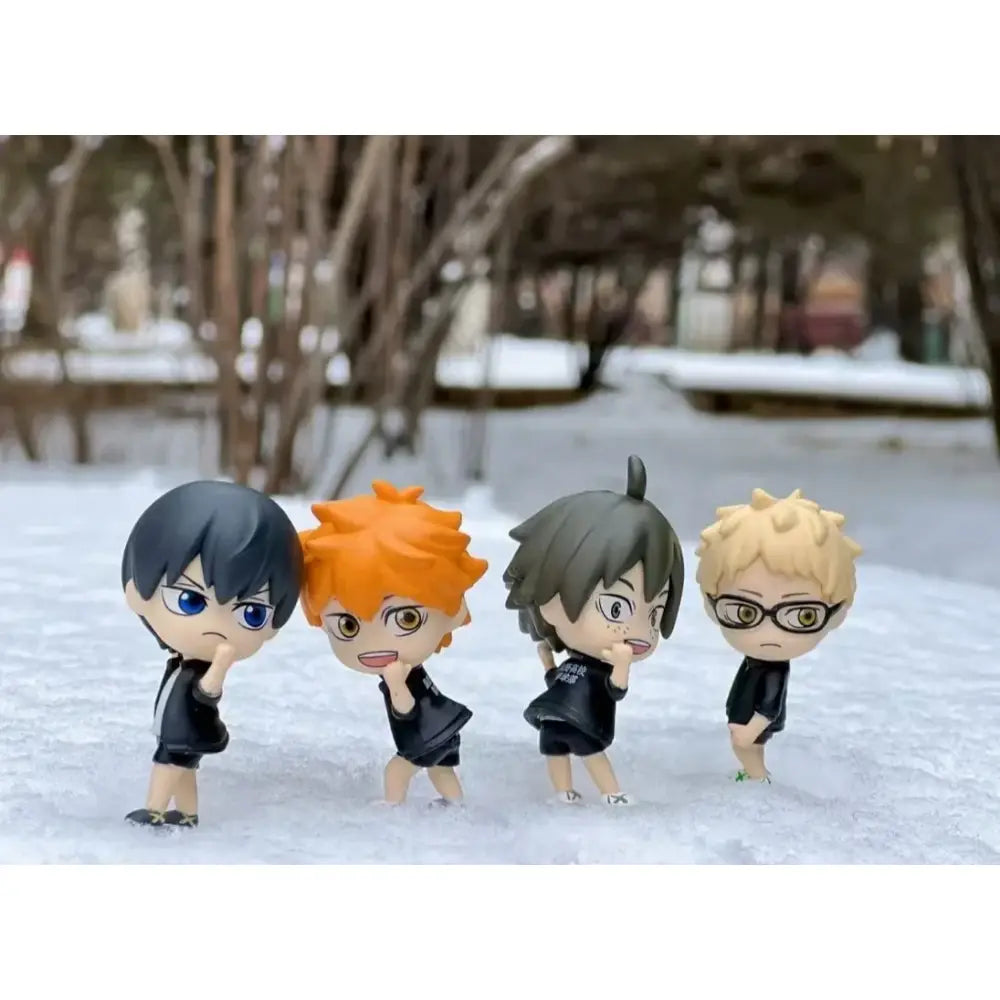 Four chibi-style volleyball boys figurines with black athletic outfits and distinct hair colors ideal for unboxing video and support returns