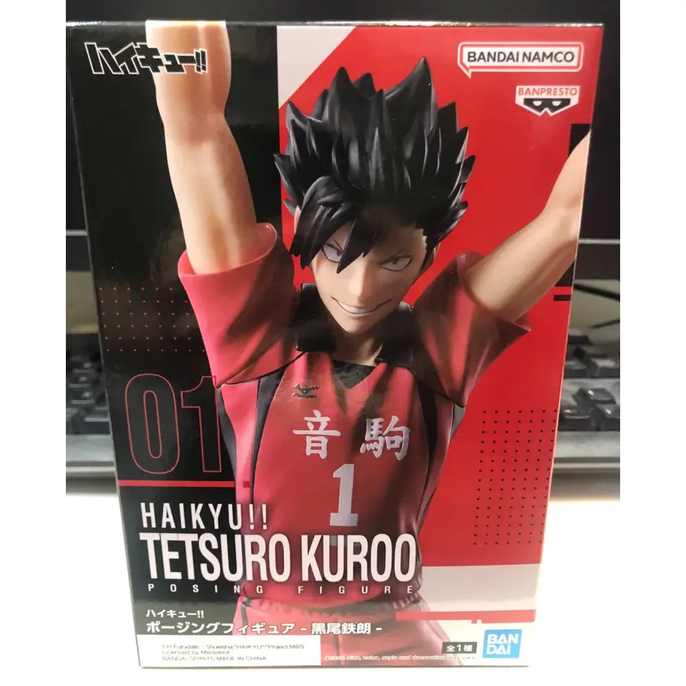 Black-haired smiling tetsuro kuroo banpresto posing figure in red and black jersey number 1 from figure anime haikyu