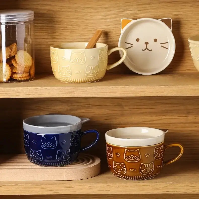 Cream-colored ceramic Japanese cat mug with cat ear lid and subtle face pattern with matching small dish
