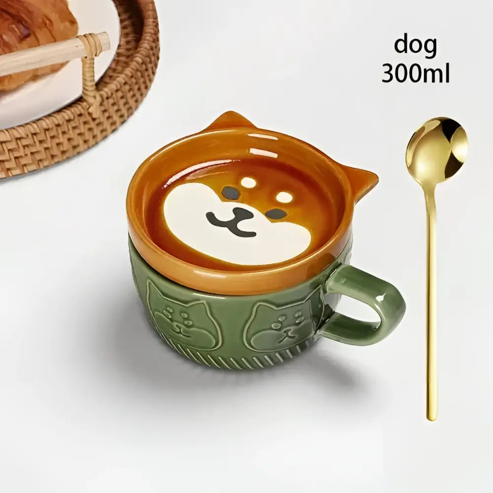 A charming green ceramic Japanese cat mug with a dog head lid and matching small dish with orange interior