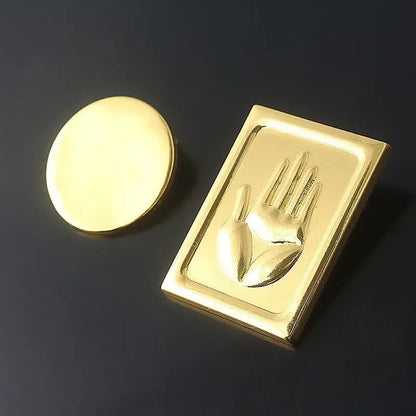Gold-colored metal badge featuring a raised hand design with matching cap for jojo’s bizarre adventure kujo jotaro cosplay