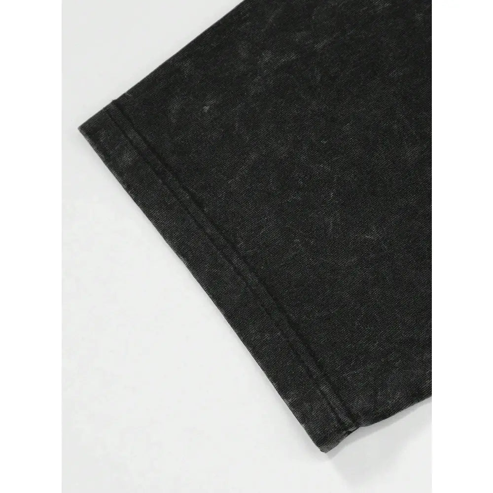 Black denim fabric with faded worn texture and visible stitching on hem of jujutsu kaisen choso graphic t-shirt washed vintage