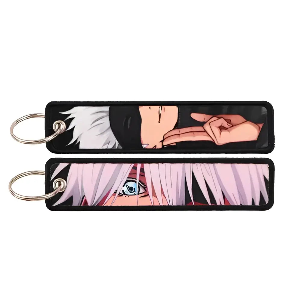 Black fabric keychain with gojo satoru embroidery featuring white hair blue eyes and silver metal rings for bags