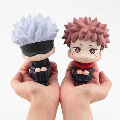 Two jujutsu kaisen chibi sitting dolls with spiky white and pink hair in movable sitting pvc figurines