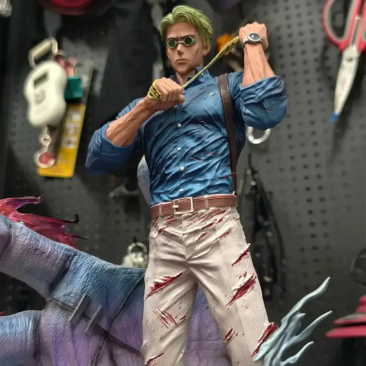 Detailed nanami kento pvc statue from jujutsu kaisen featuring green hair, round goggles, blue shirt, and stained beige pants