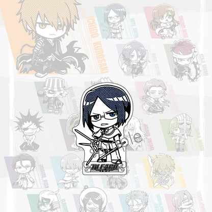 Black and white chibi bleach character acrylic badge with two swords and bleach logo paired with jujutsu kaisen acrylic stand