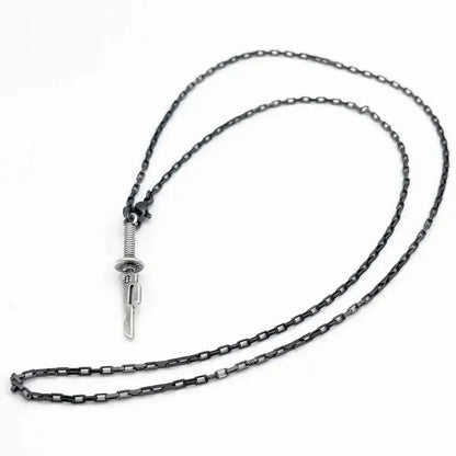 A sleek dark-toned chain necklace with a silver jujutsu kaisen toji fushiguro sword pendant featuring engraved blade and textured hilt