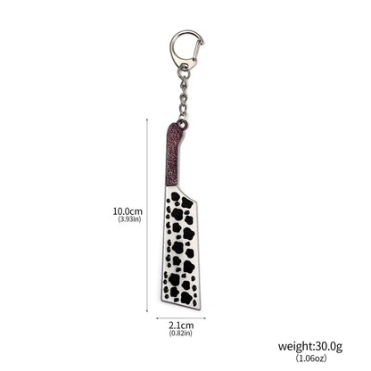 Metallic jujutsu kaisen toji inverted spear keychain shaped like a cleaver with glittery burgundy handle and black paw prints