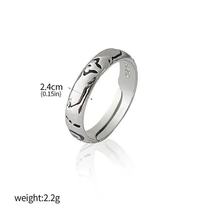 Silver jujutsu kaisen yuta okkotsu couple ring with intricate black engraved patterns along its band